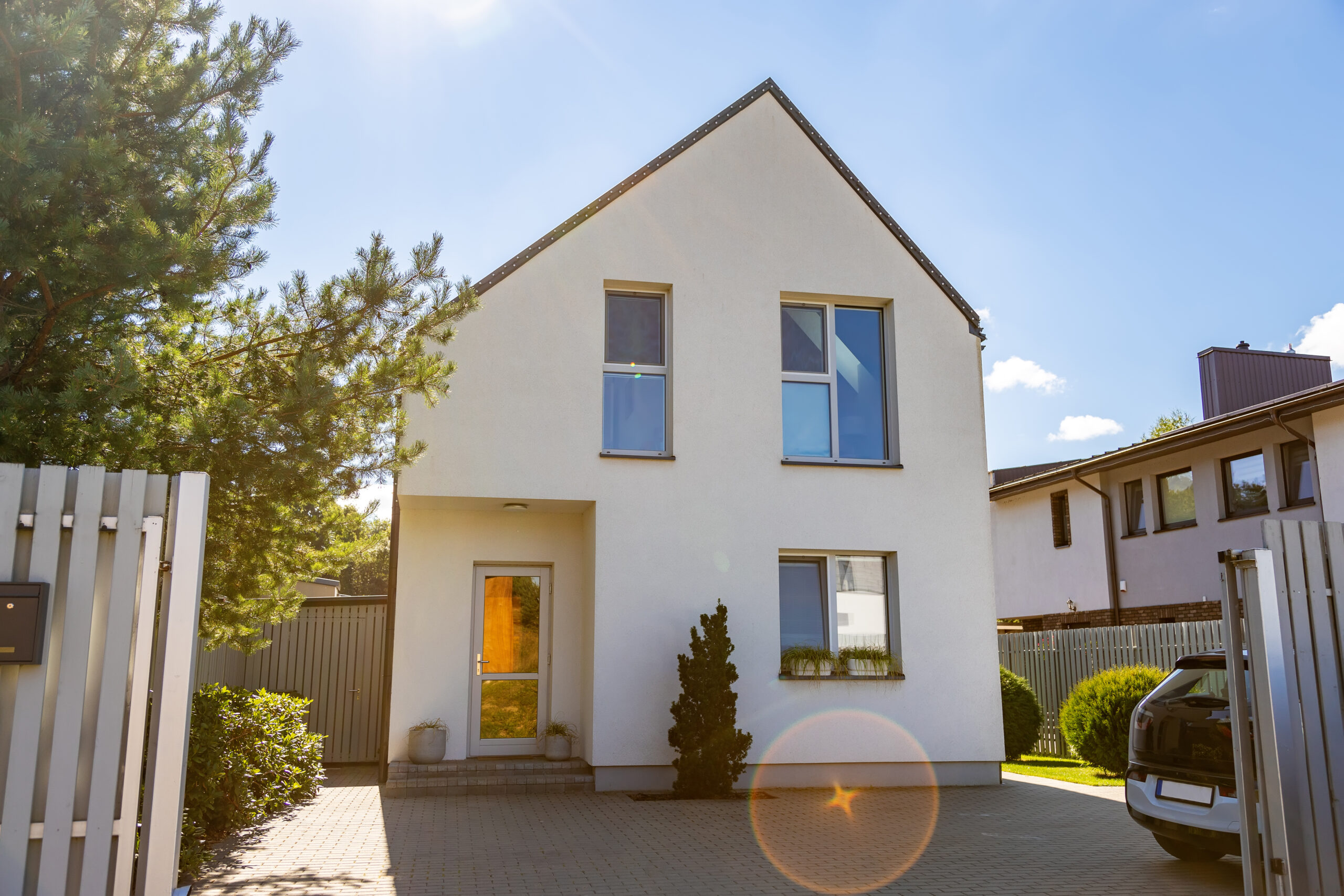 Outside view of a simple, private, contemporary house on a sunny day.